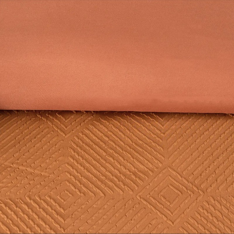 How to complement geometric embossed bedding with bedroom furniture?